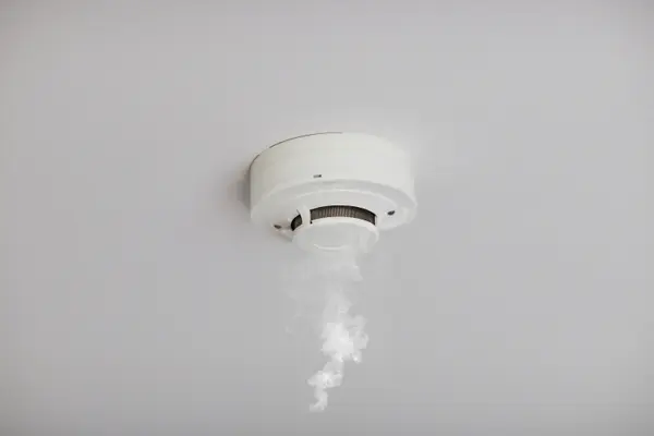 a smoke detector hanging from the ceiling of a house from Electrician Richardson TX in Richardson, TX - Electrical ceiling fan installation