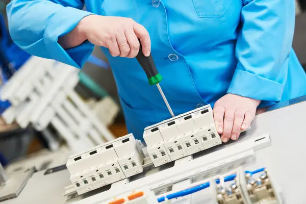 a tecnician screwing an electrical braker from Electrician Richardson TX in Richardson, TX - Electrical wiring redesign